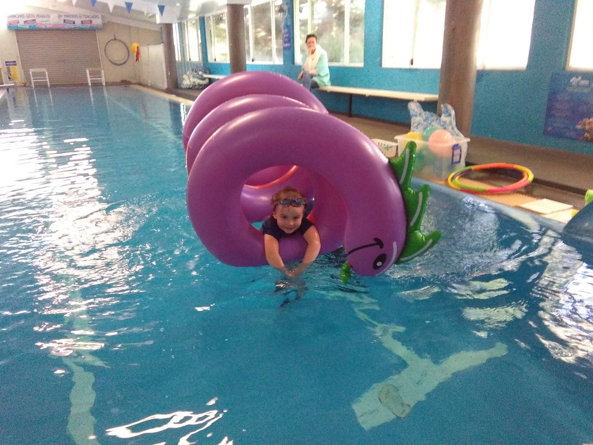 Child in a Pink Float Ring in an Indoor Pool — Swim Care Boambee in Coffs Harbour, NSW