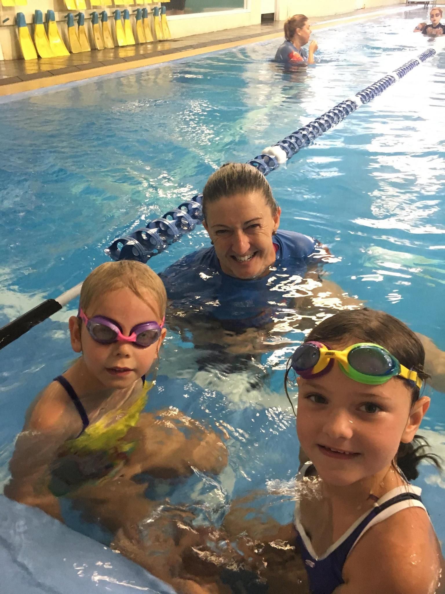 Woman and Two Children in Pool Wearing Swim Goggles — Swim Care Boambee in Coffs Harbour, NSW