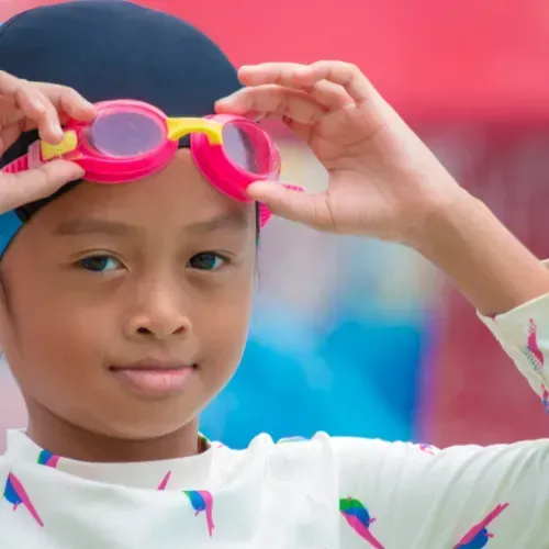 Girl Wearing Swimming Cap and Goggles โ Swim Care Boambee in Coffs Harbour, NSW