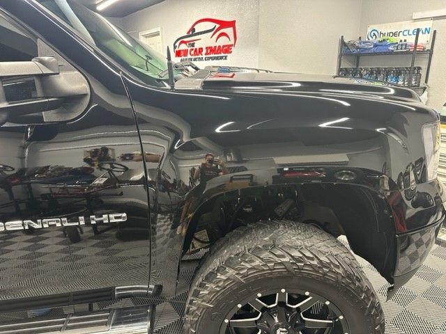 A black sierra nevada truck is parked in a garage