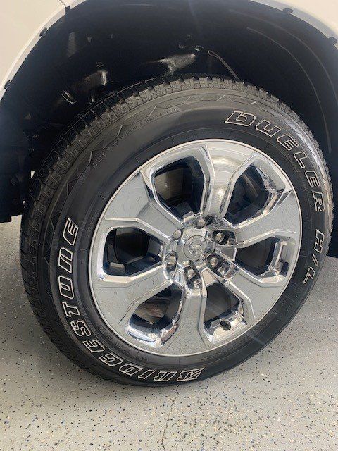 A close up of a tire on a white truck.