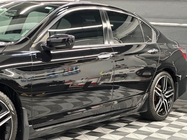 A black car is parked on a checkered floor.