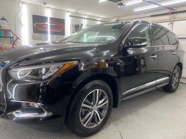 A black suv is parked in a garage.