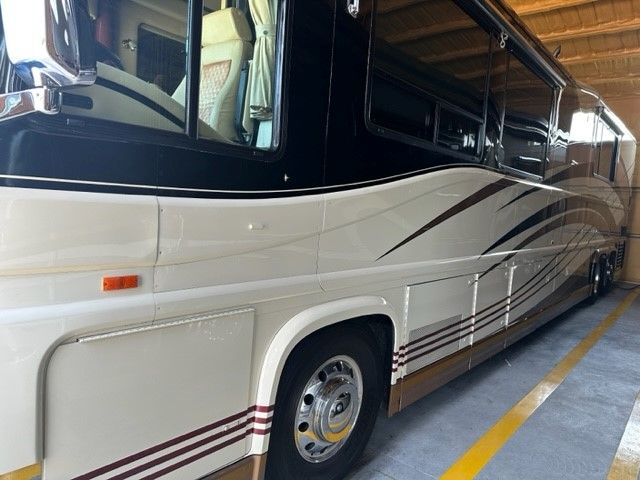A large white bus is parked in a parking garage