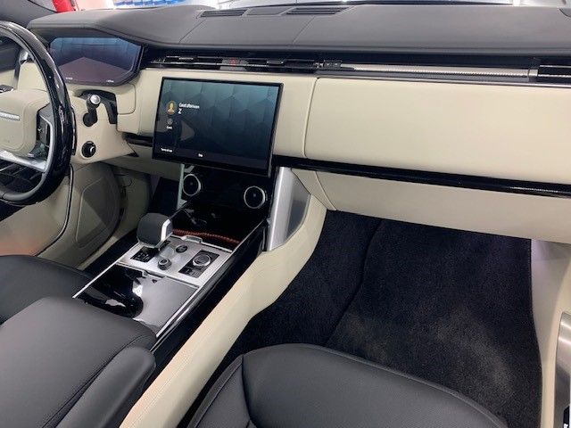 The interior of a car with a steering wheel and dashboard
