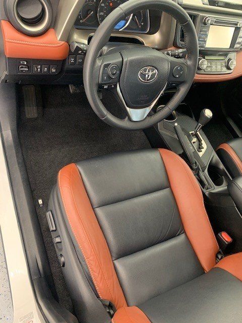 The interior of a toyota rav4 with black and brown seats
