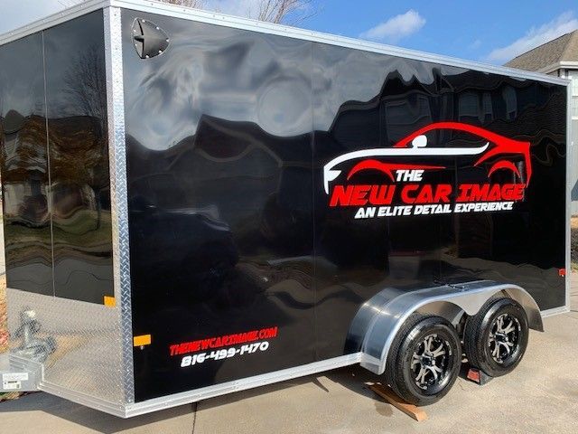 A black trailer with the words the new car trade on it