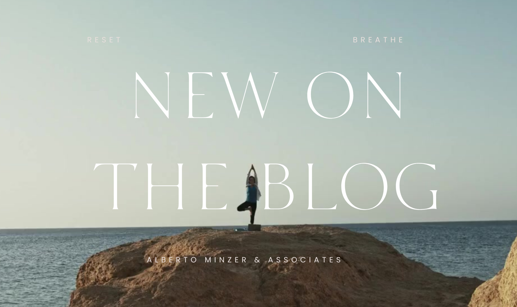 Person standing on a rocky cliff by the sea under the text “NEW ON THE BLOG”