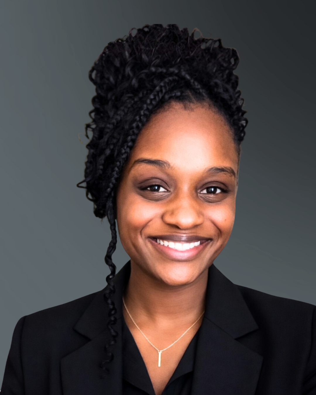 Smiling woman in a black blazer against a gray studio background