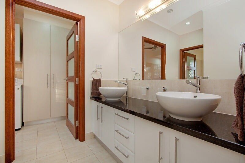 A Bathroom with Two Sinks and A Mirror — Custom Cabinets Design in Berrimah, NT