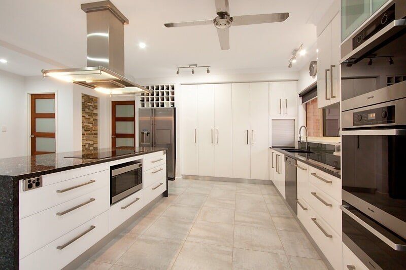 A Kitchen with Stainless Steel Appliances and White Cabinets — Custom Cabinets Design in Berrimah, NT