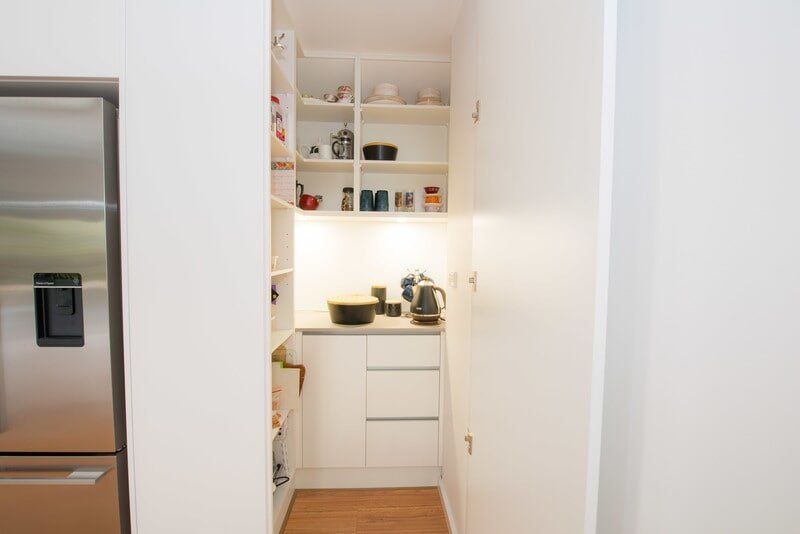 A Kitchen with A Pantry and A Refrigerator — Custom Cabinets Design in Berrimah, NT