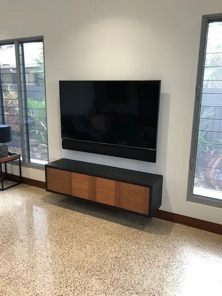 A Living Room With a Flat Screen Tv Mounted to the Wall — Custom Cabinets Design in Berrimah, NT