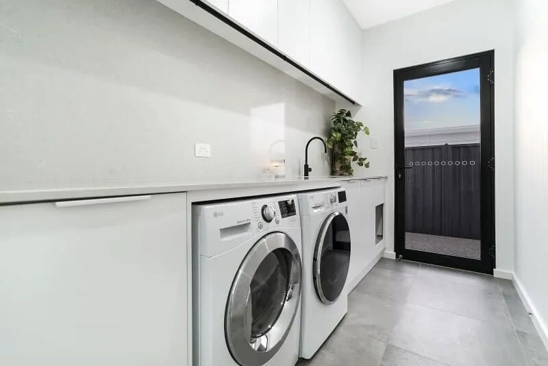 A Laundry Room With a Washer and Dryer and a Sink — Custom Cabinets Design in Berrimah, NT