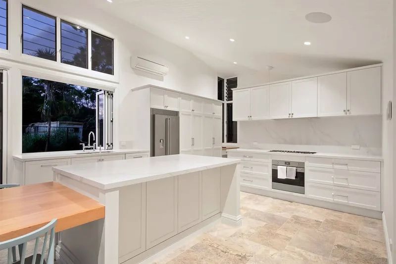 A Kitchen With White Cabinets, Granite Countertops — Custom Cabinets Design in Berrimah, NT