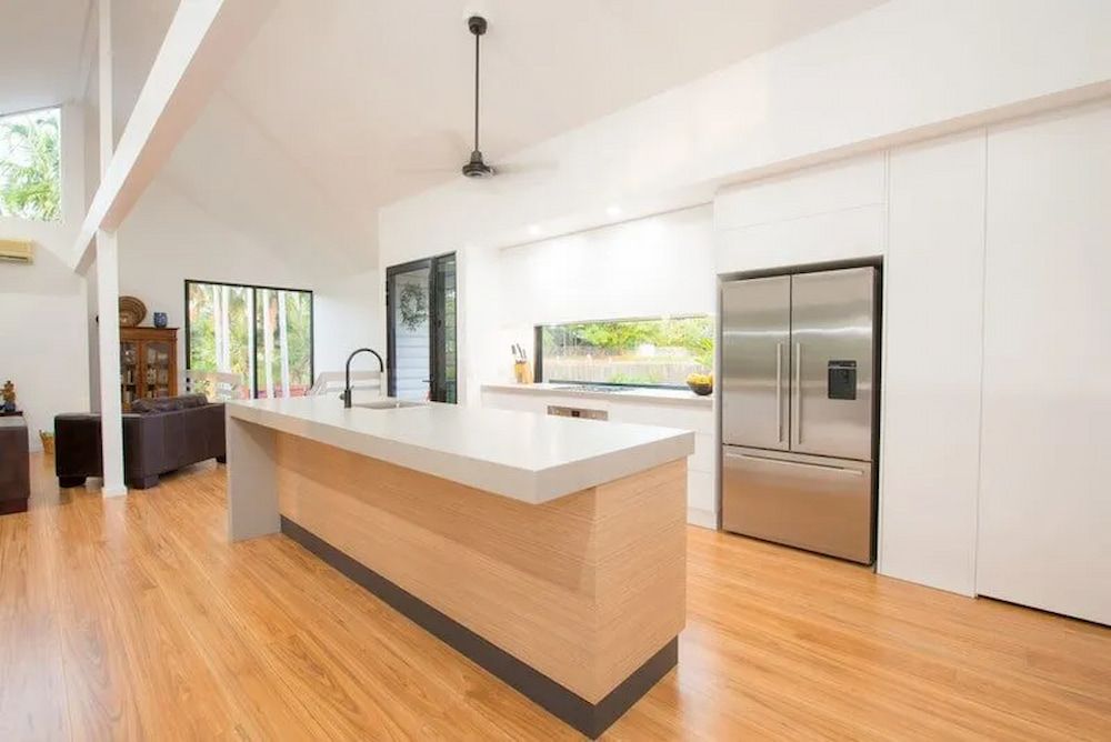 A Kitchen With a Large Island and Stainless Steel Appliances — Custom Cabinets Design in Berrimah, NT