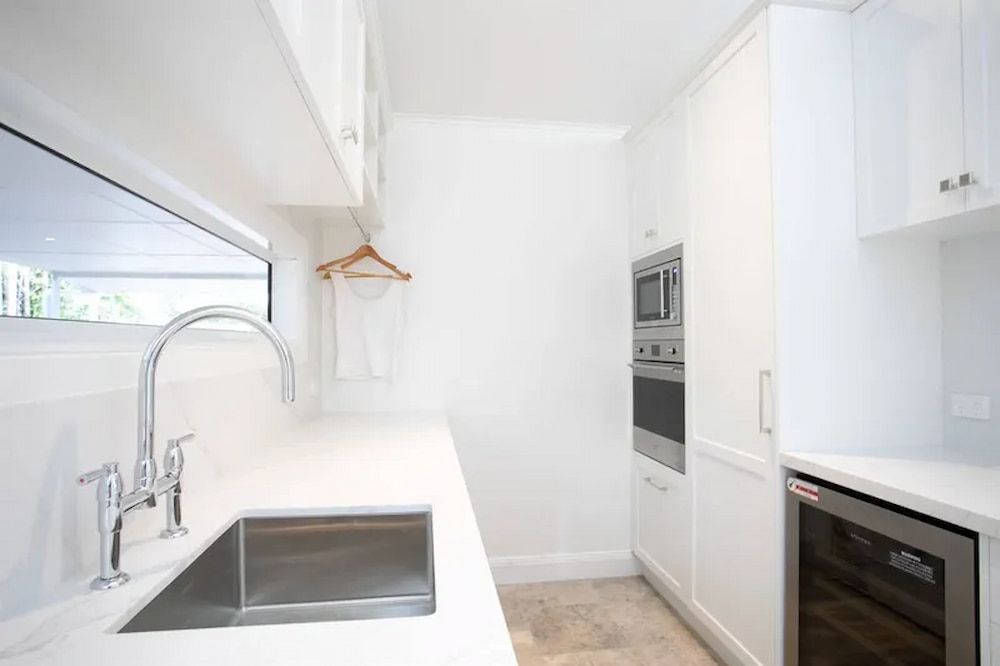 A Kitchen With White Cabinets and a Stainless Steel Sink — Custom Cabinets Design in Berrimah, NT