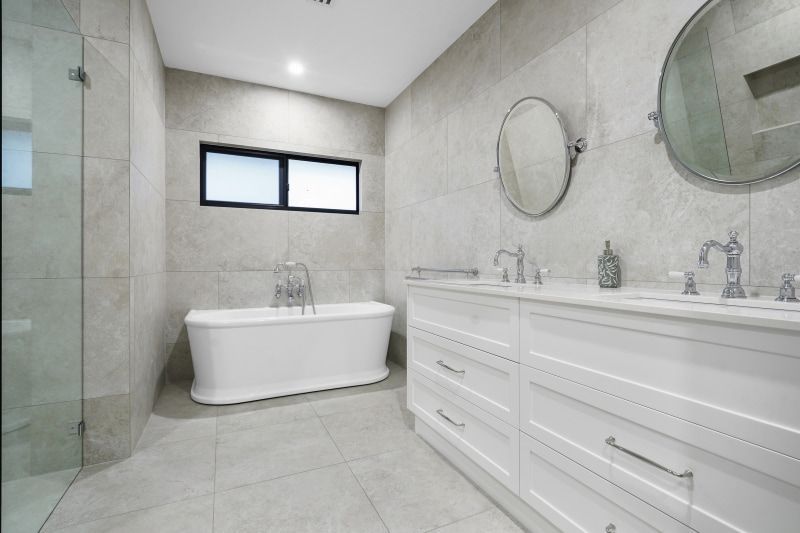 A Bathroom With a Bathtub, Mirrors and a Walk in Shower — Custom Cabinets Design in Berrimah, NT