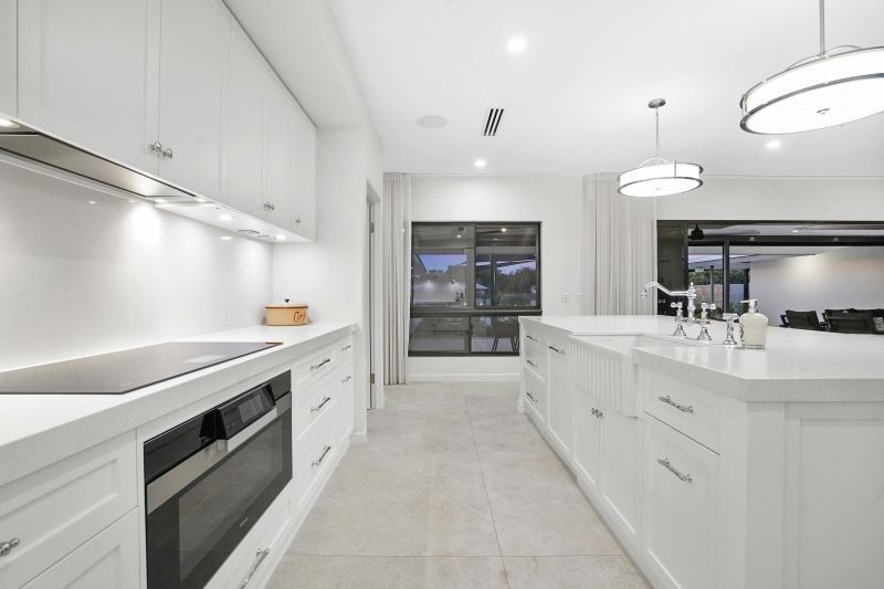 A Kitchen With White Cabinets and Stainless Steel Appliances — Custom Cabinets Design in Berrimah, NT