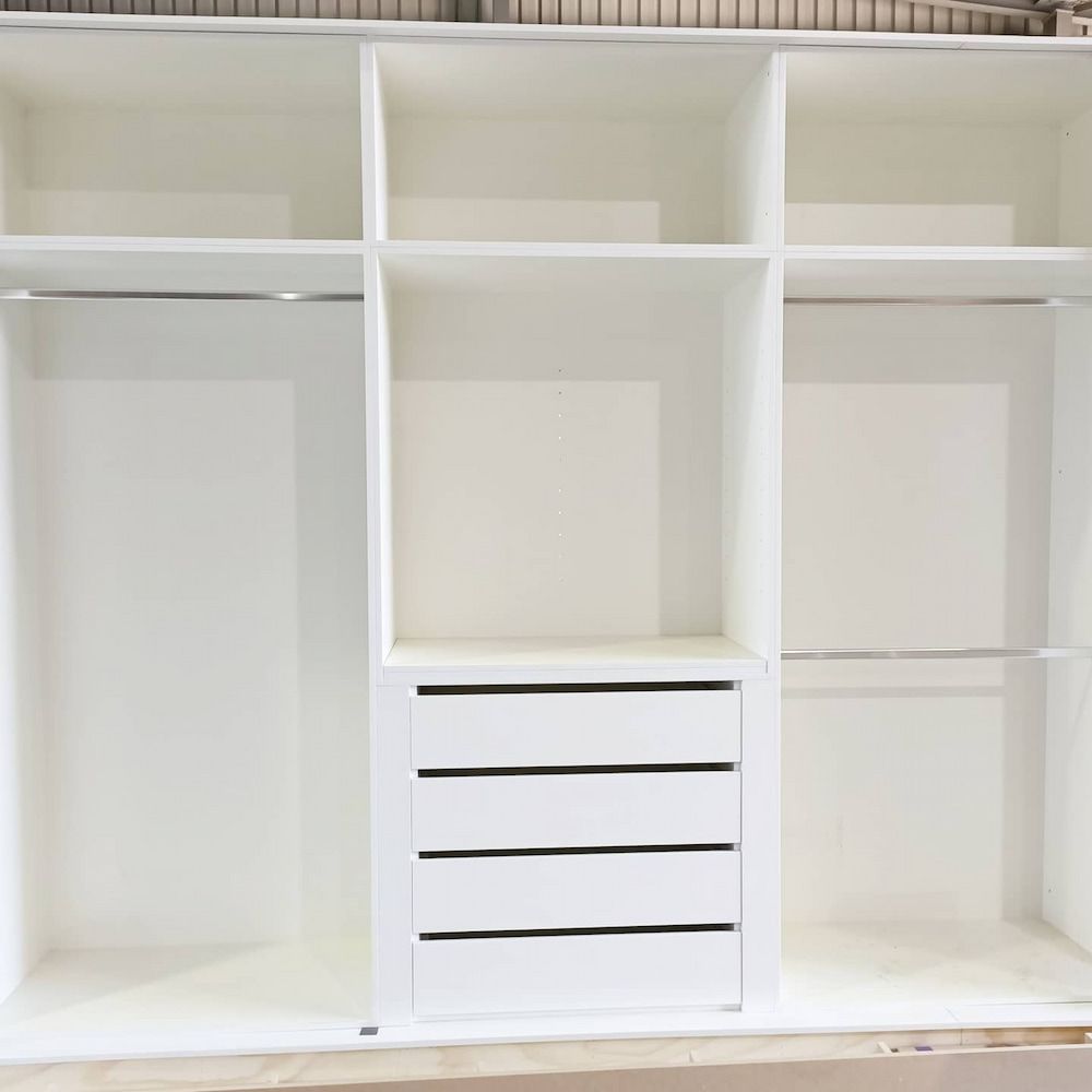 A Large Empty White Wardrobe With Drawers and Shelves — Custom Cabinets Design in Berrimah, NT