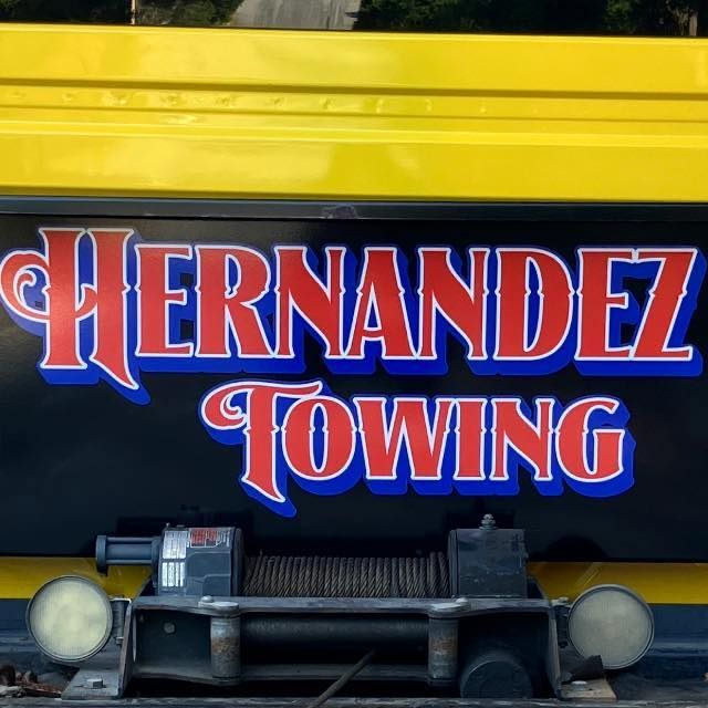 Hernandez Towing logo on a yellow and black tow truck. Red text with blue and white accents. Hernandez Towing logo on a yellow and black tow truck. Red text with blue and white accents.