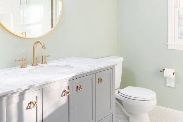 A Bathroom with Sink, Toilet, and Mirror A Bathroom with Sink, Toilet, and Mirror