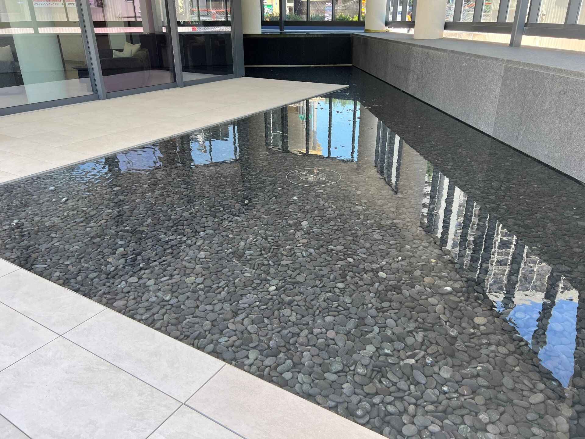 A reflection of a building in a pool of water