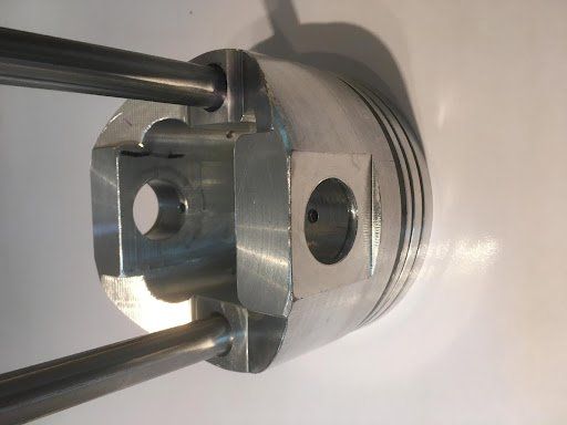piston with stabilizer bars attached