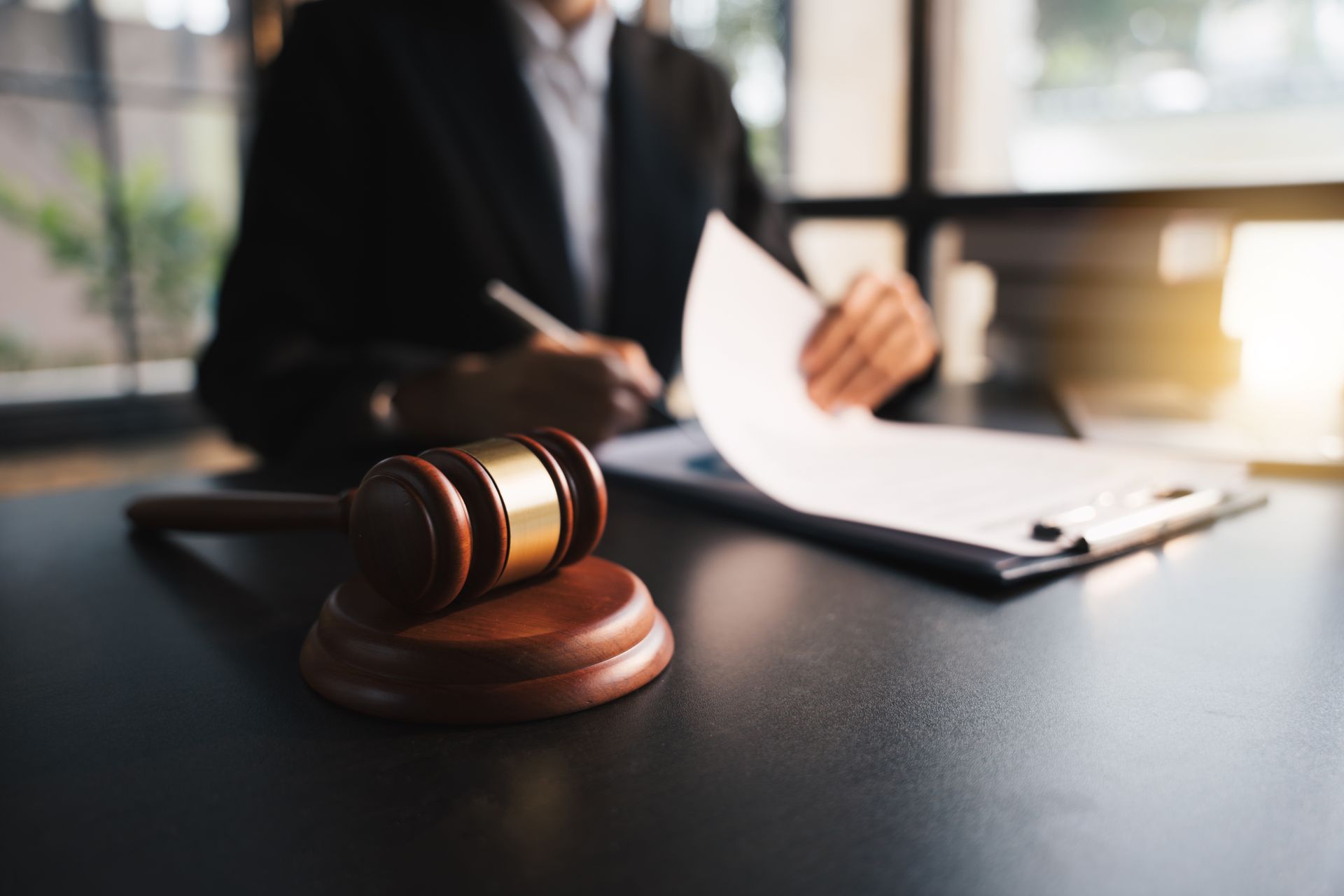 Local bankruptcy attorney reviewing legal documents at a desk beside a wooden gavel.