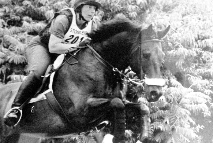 A rider on a horse jumping an obstacle during an equestrian competition.