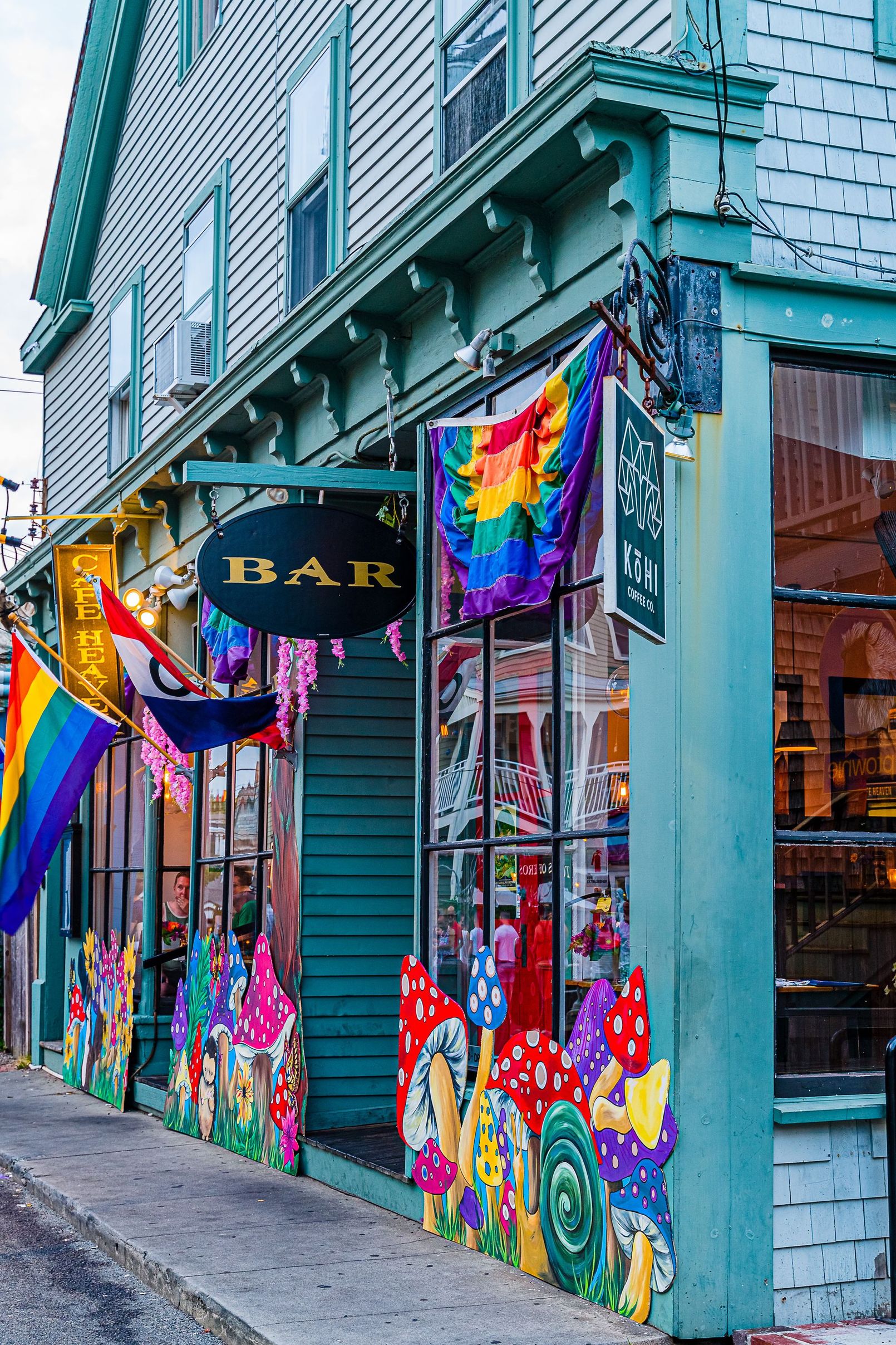 A colorful building with a sign that says bar on it