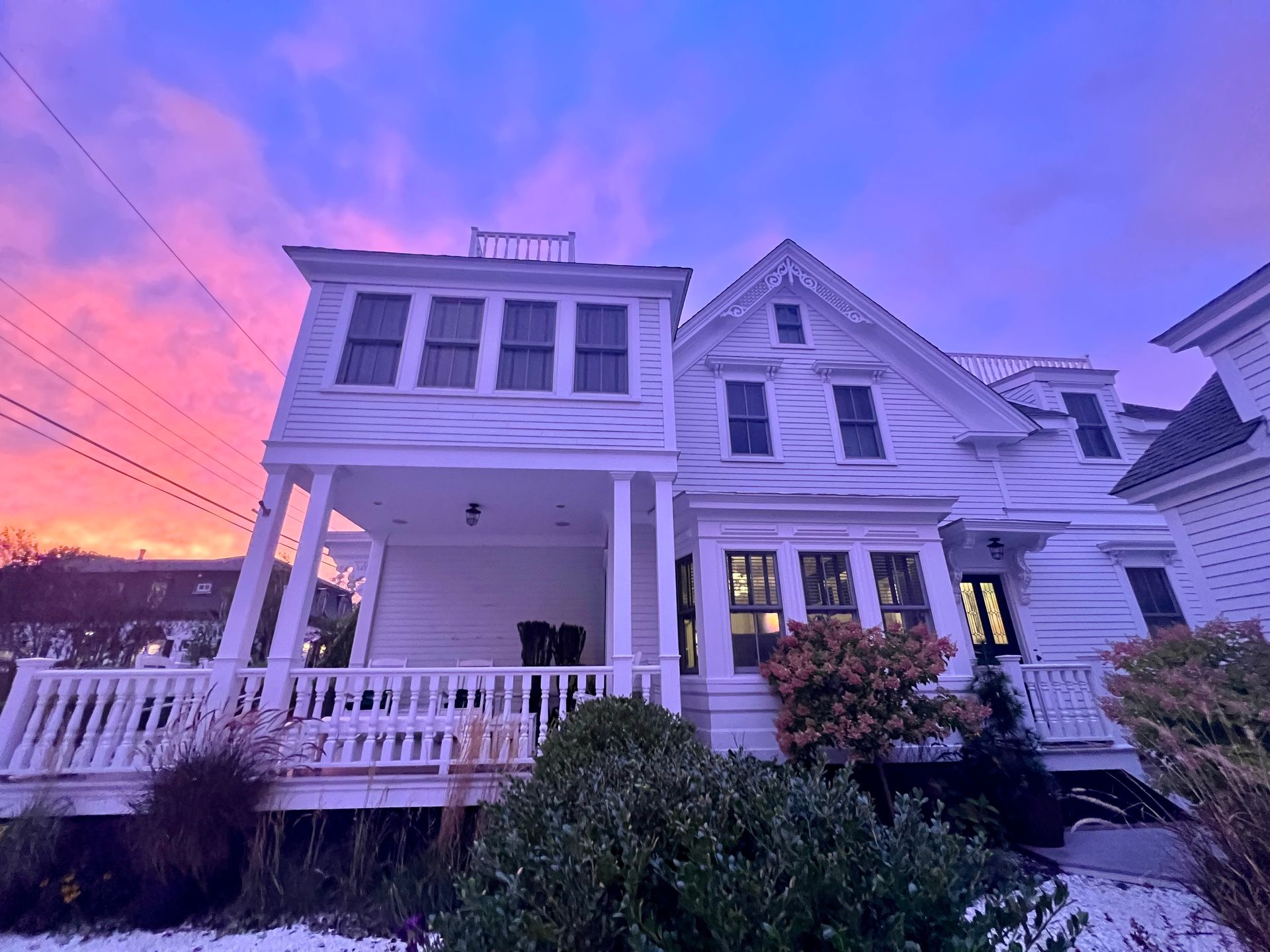 exterior picture of the main house during a very purple sunset