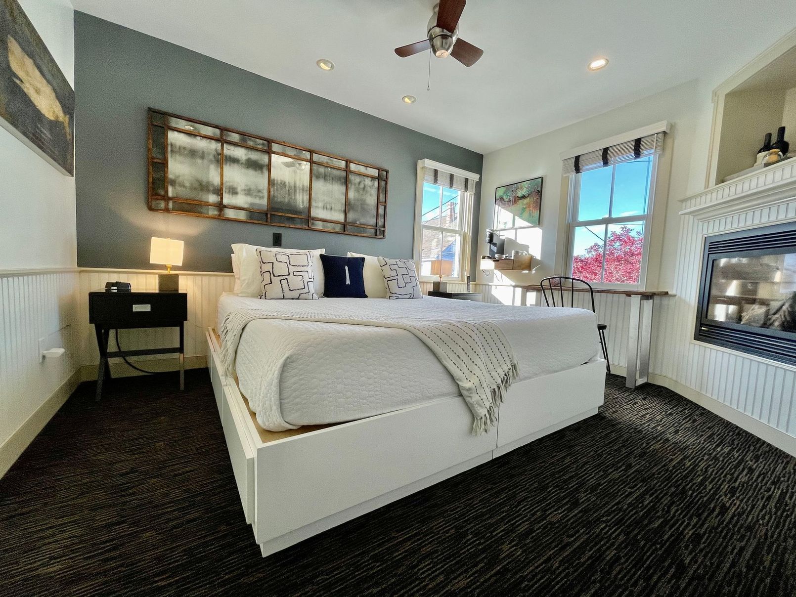A bedroom with a king size bed and a fireplace.