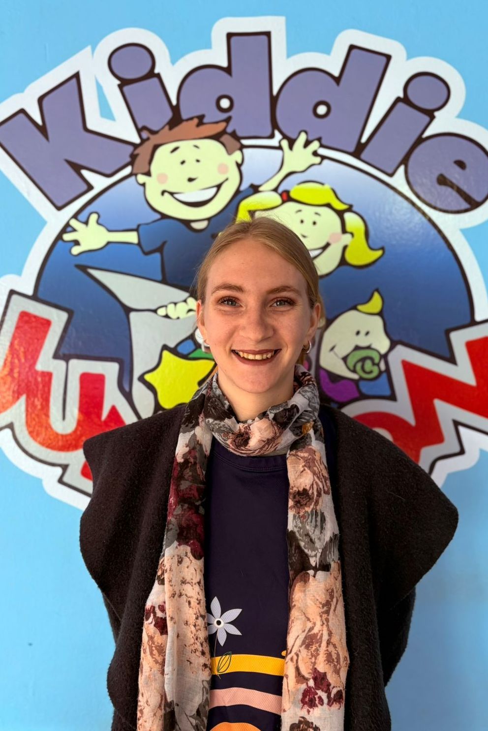 Woman smiling in front of a 