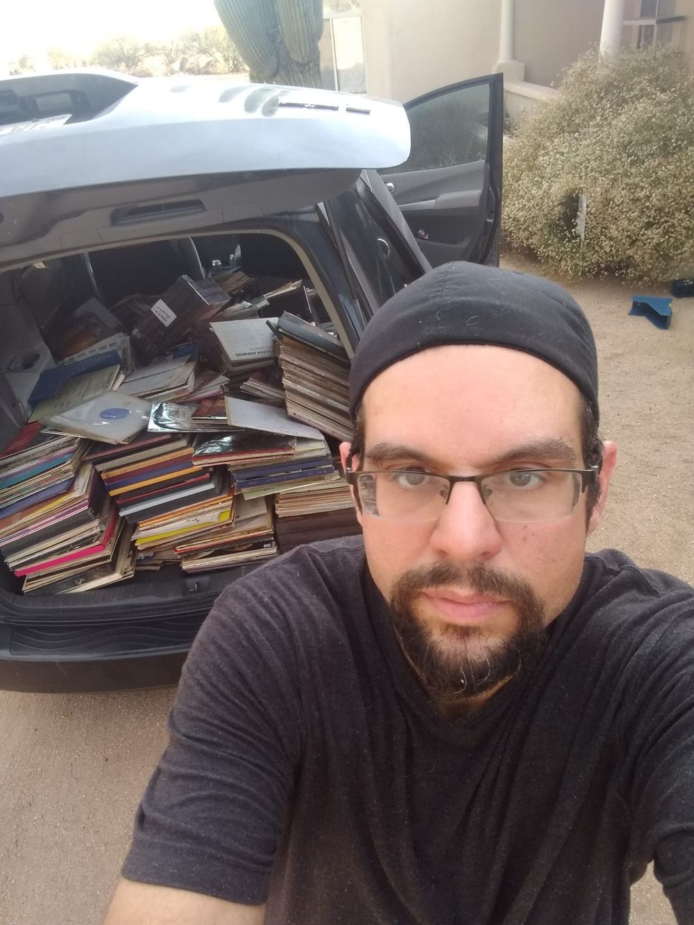 Joseph, a Maricopa County record buyer, in front of his SUV packed with LPs from a collection he just bought