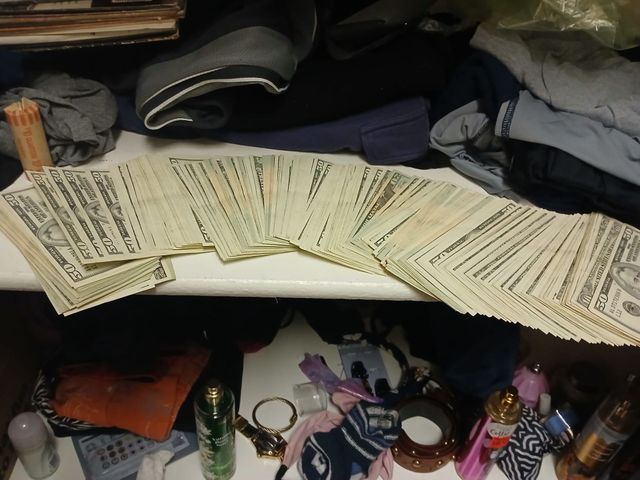 $20 and $50 bills fanned out, ready to pay for a record collection