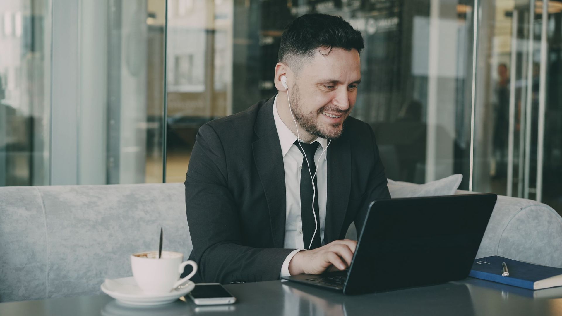 Business owner working on a laptop, relying on a fast business broadband connection.