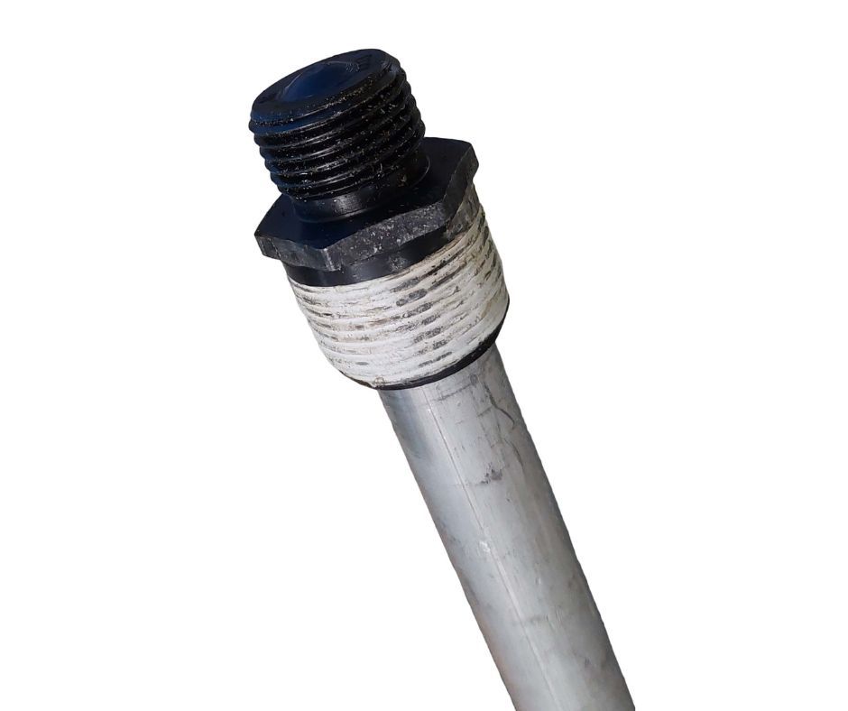 Close-up of a black threaded pipe fitting on a light gray metal rod.