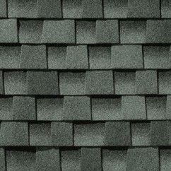 A close up of a roof with slate shingles on it.