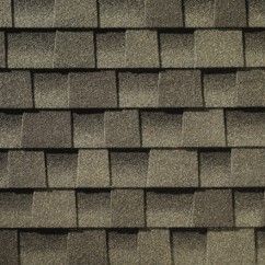 A close up of a roof with weathered wood shingles on it.