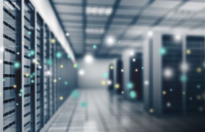 a blurred image of a server room with lots of servers .