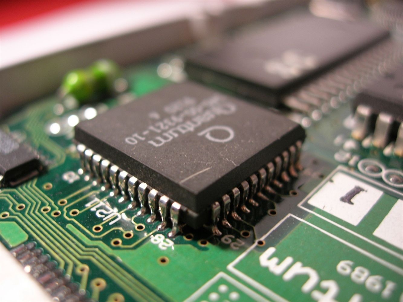 a close up of a computer chip on a green board