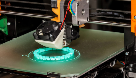 A close up of a 3d printer printing a bracelet
