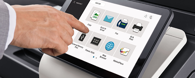 A person is using a tablet to control a printer.