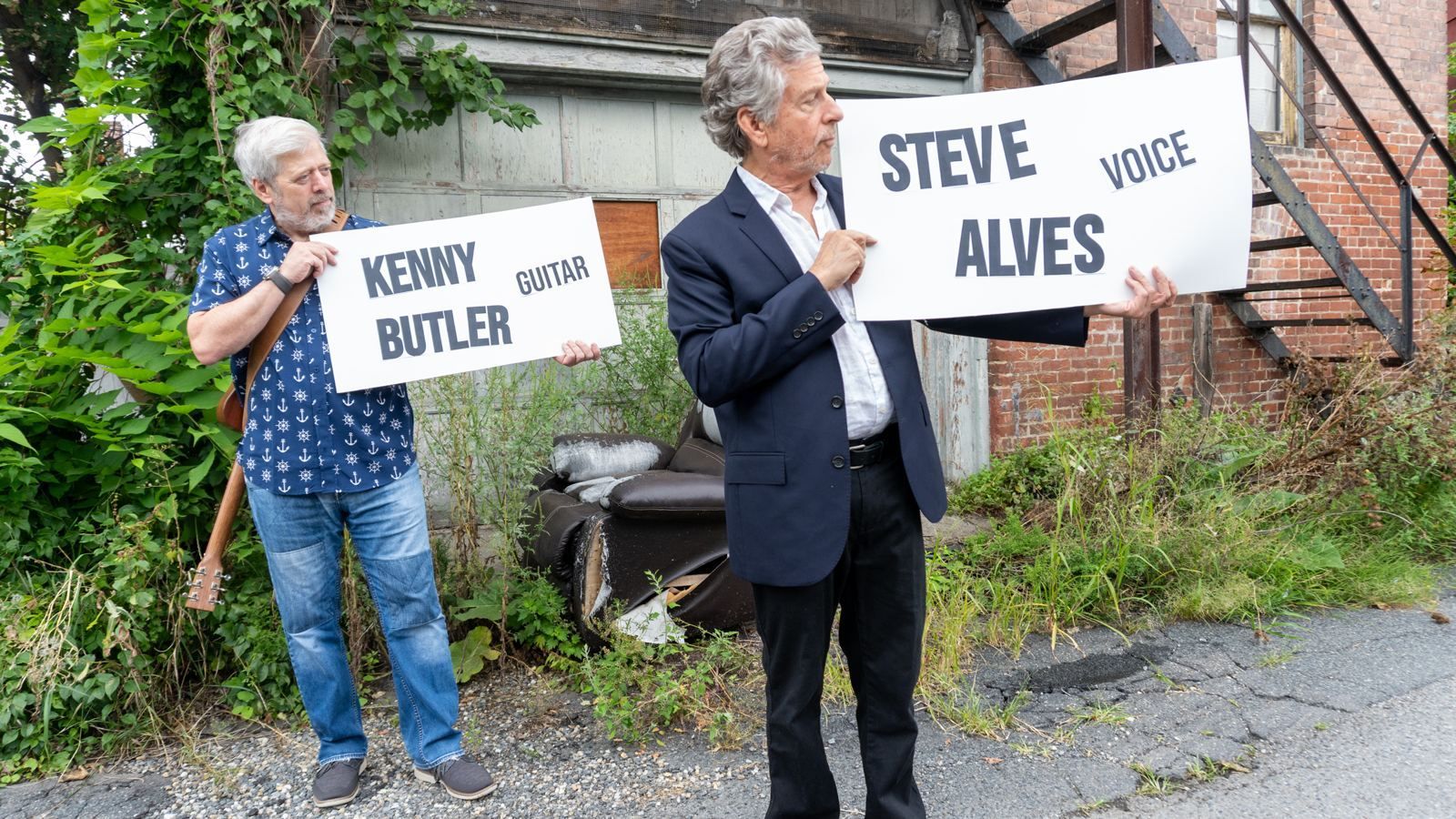 Steve Alves and Kenny Butler beside a weathered wooden door