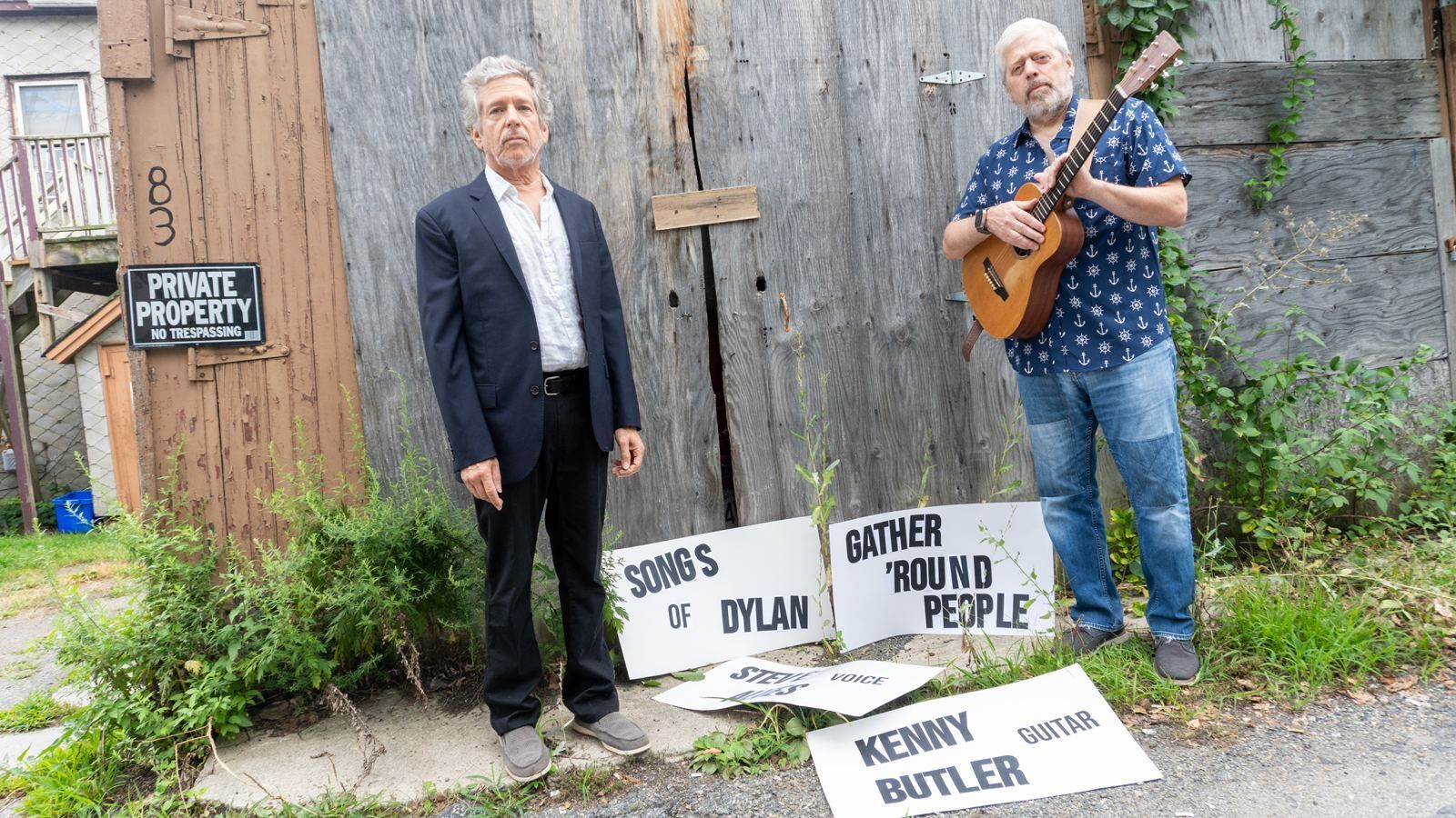Kenny Butler and Steve Alves holding signs with their names