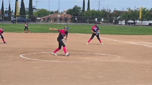 Baseball player sliding into base as another player attempts to catch the ball.