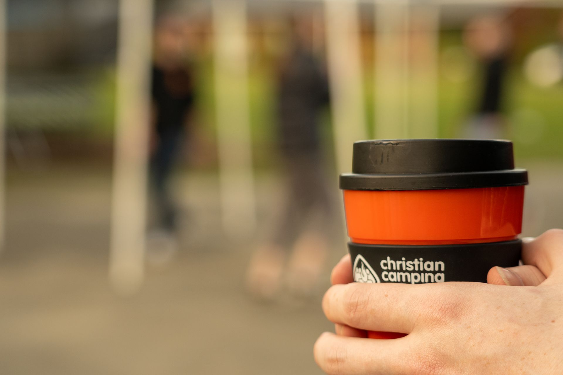 A person is holding a cup of coffee in their hand.
