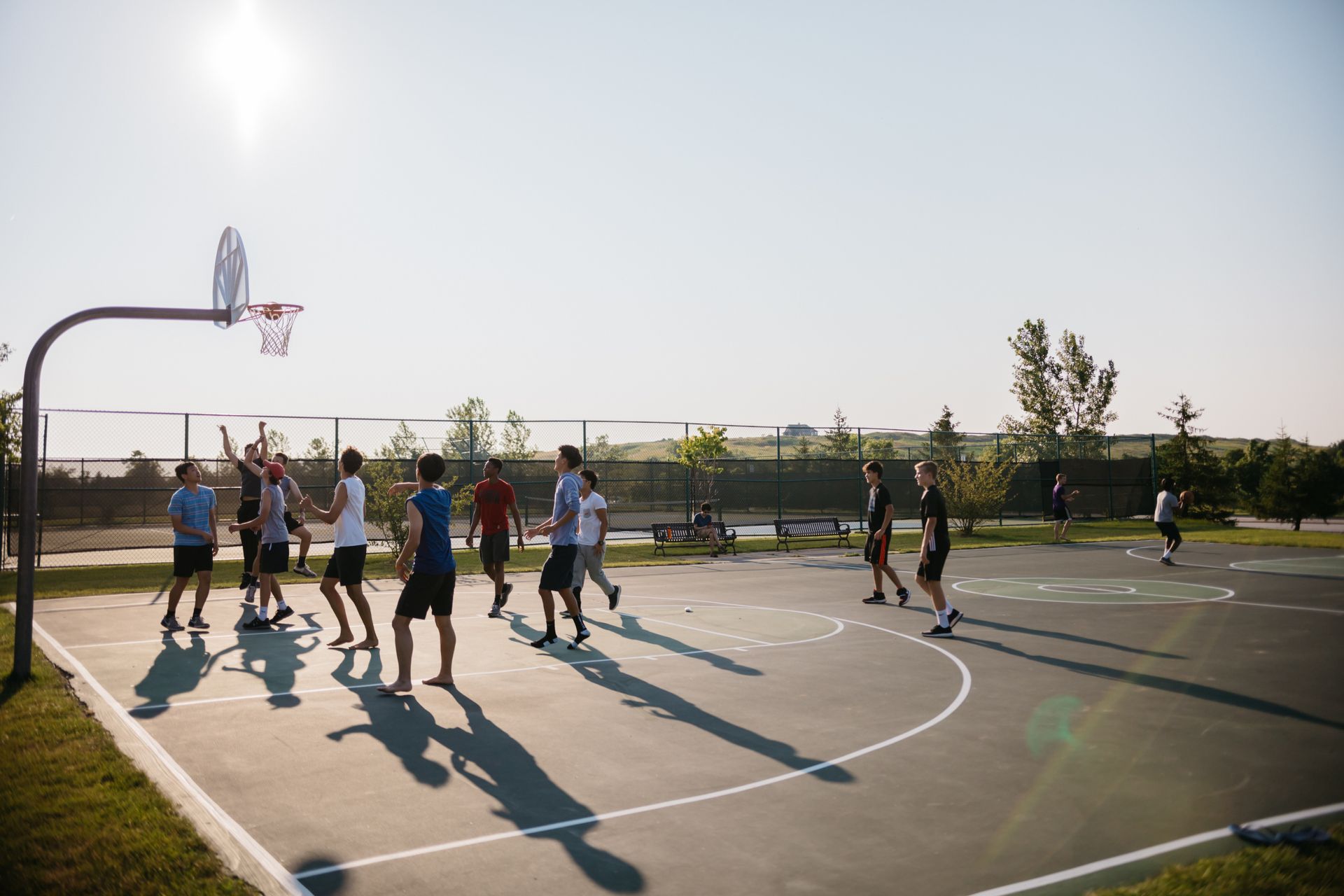 A group of people are playing basketball on a court.