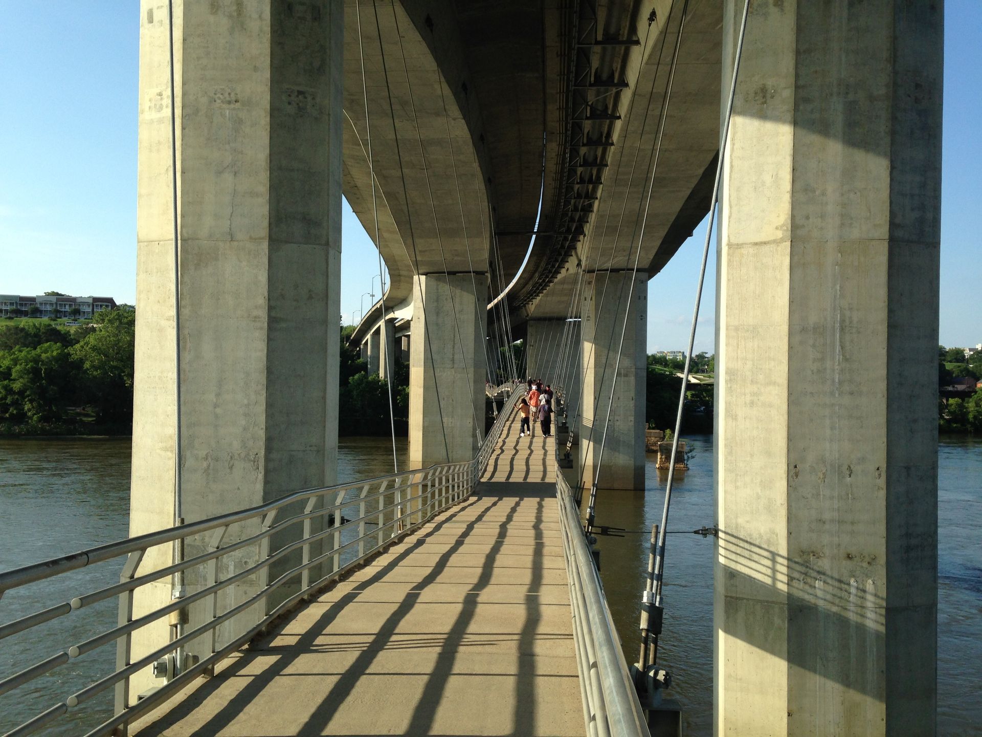 A bridge over a body of water with people walking on it